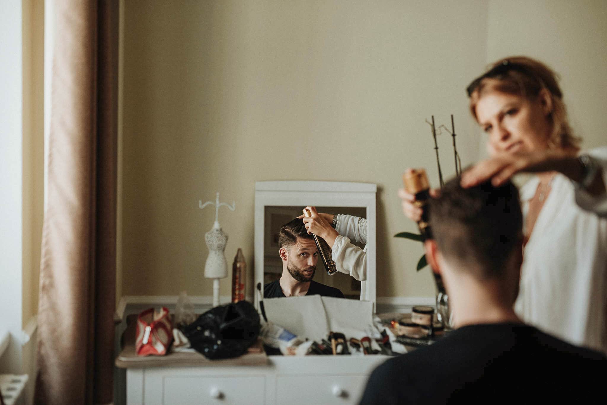 groom getting his hair done