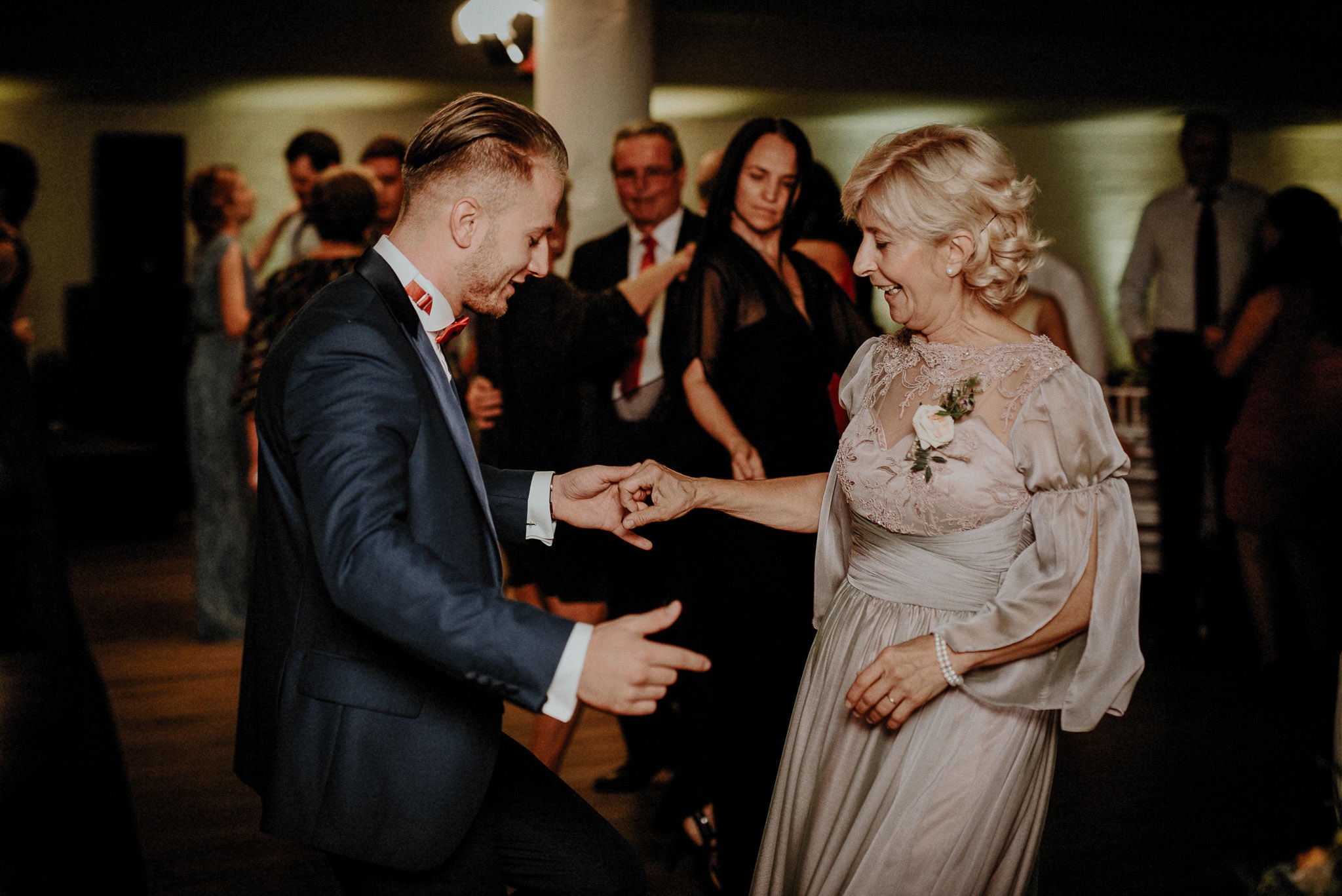 bride's brother dancing with their mother