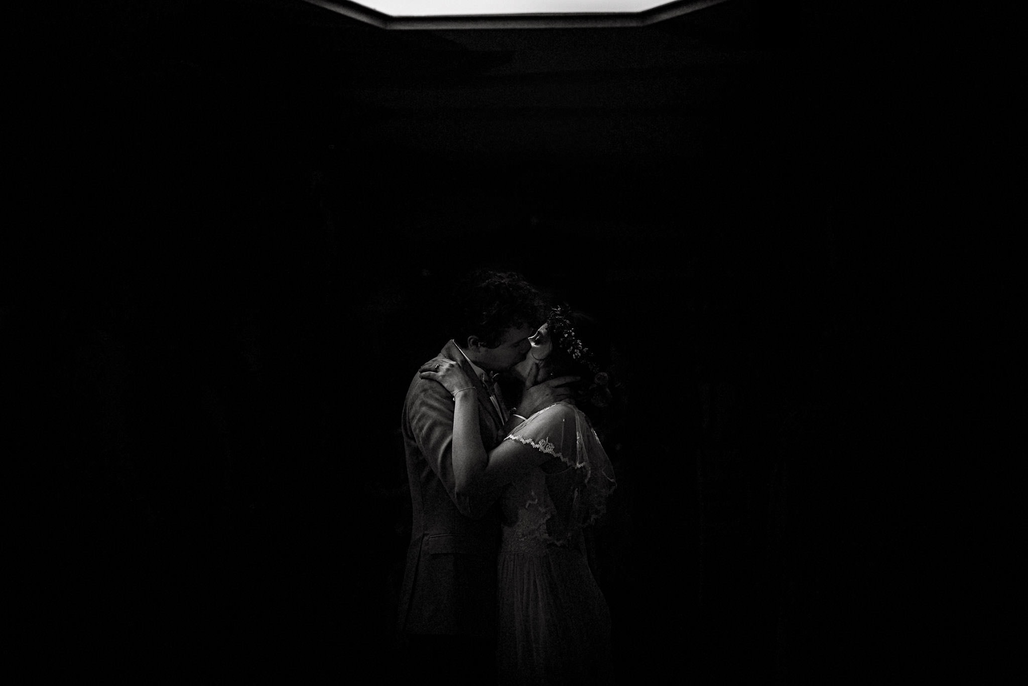 intimate kiss between the bride and groom