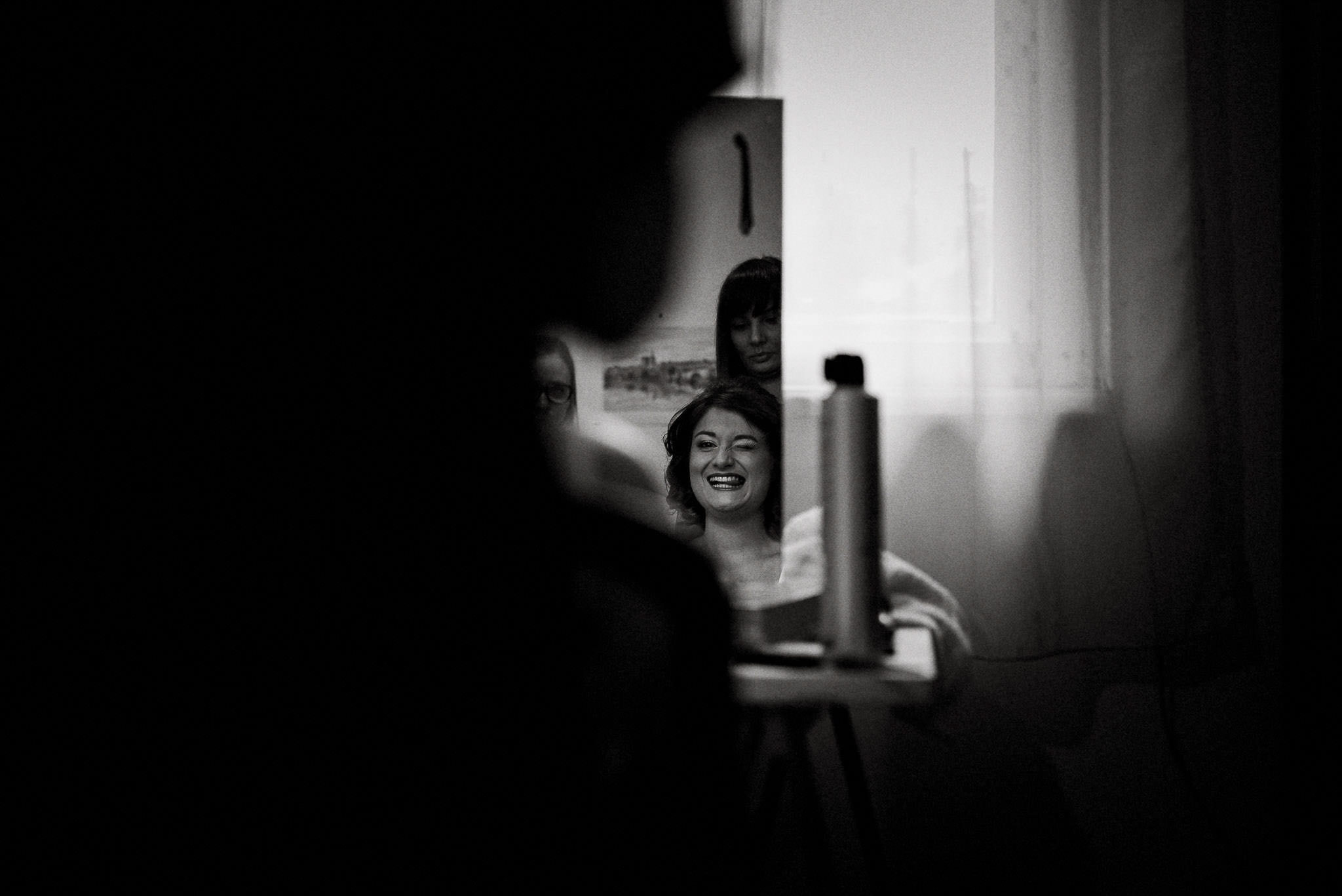 happy bride smiling in the mirror