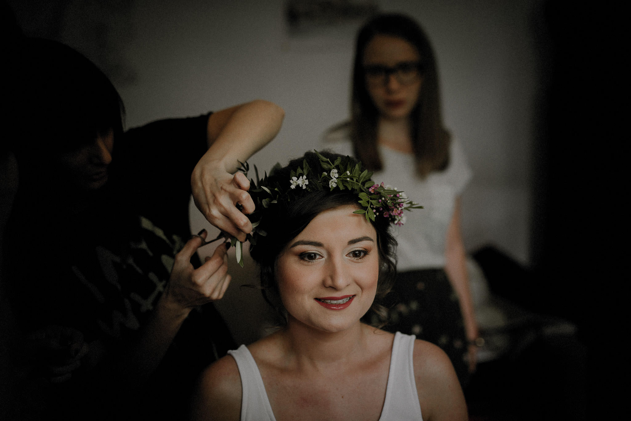 lighthearted bride getting her colourful floral crown on