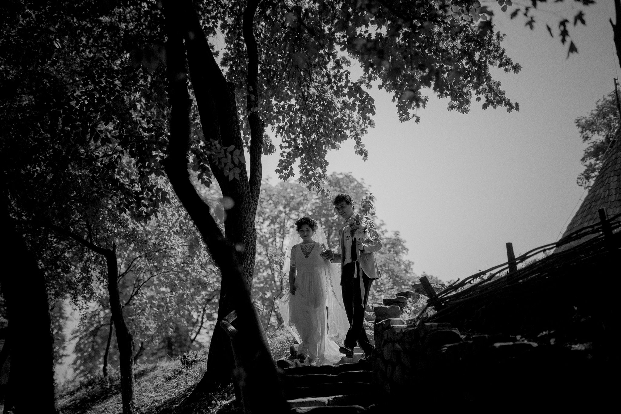 bride and groom walking together on their sunny wedding day