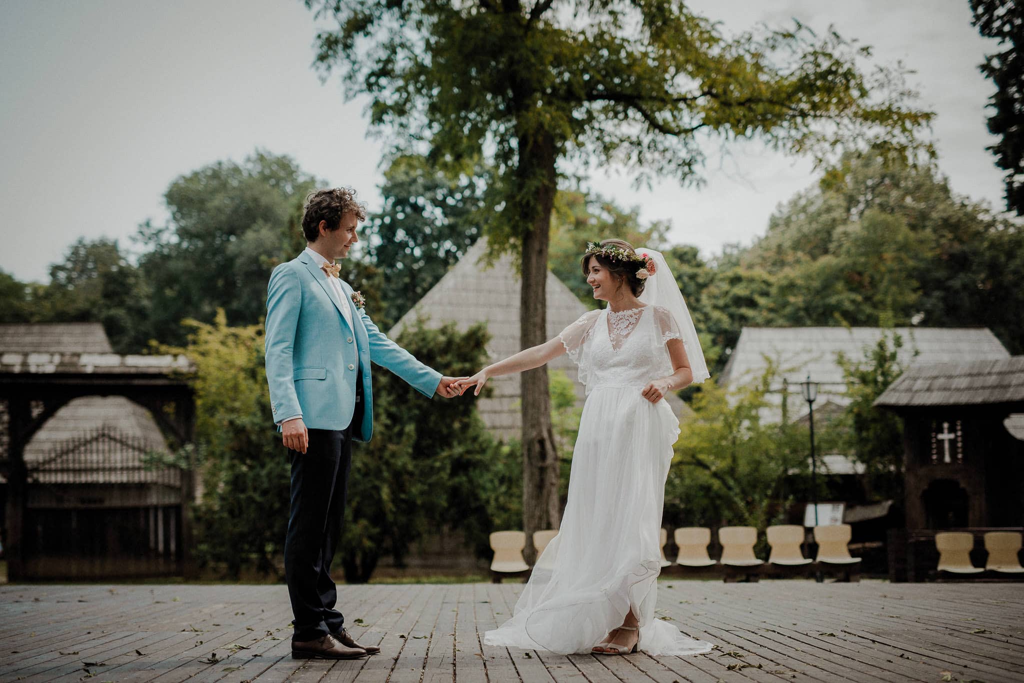 lighthearted bride and groom practice their first dance outdoors