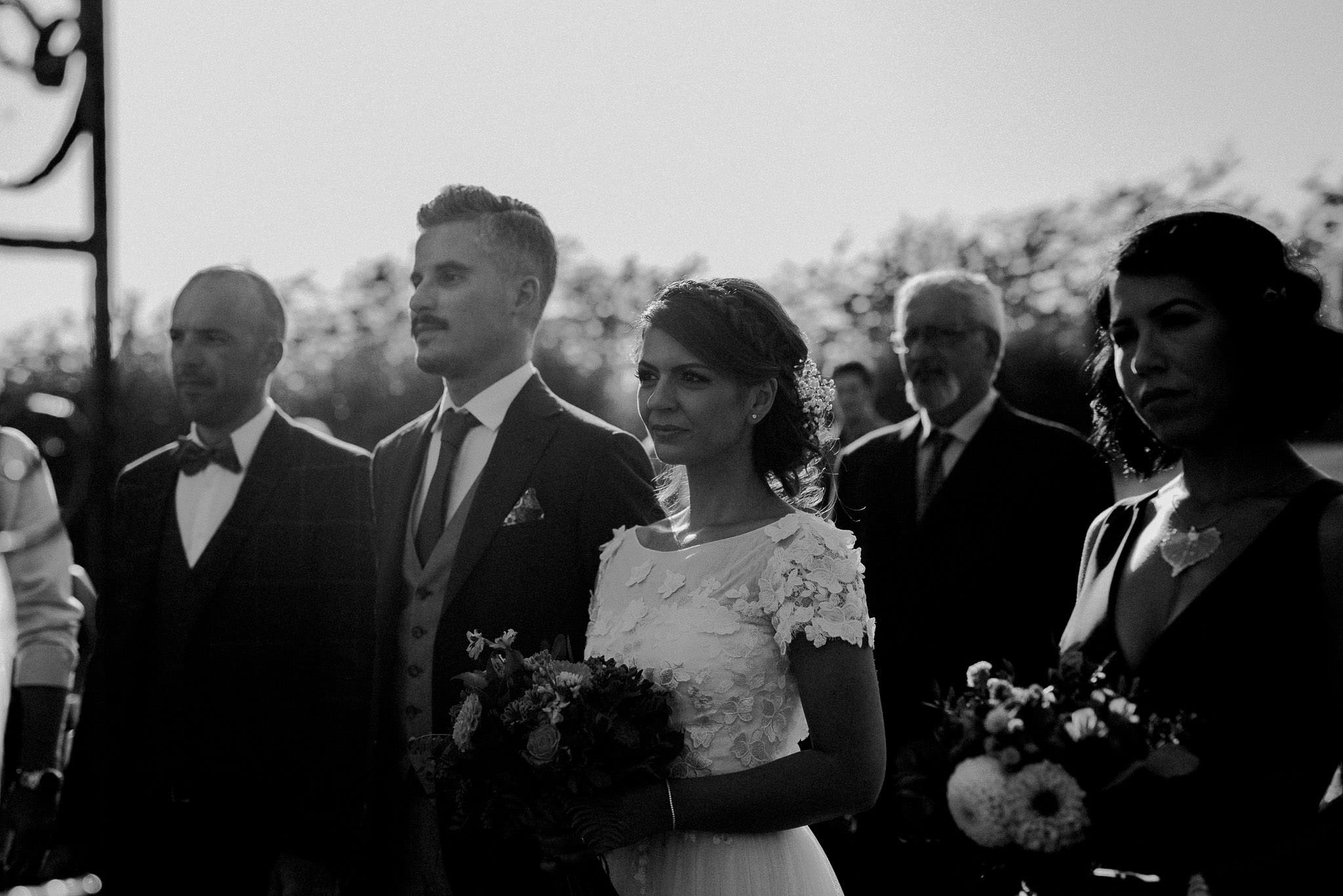 bride and groom during their sunny outdoor wedding ceremony during september
