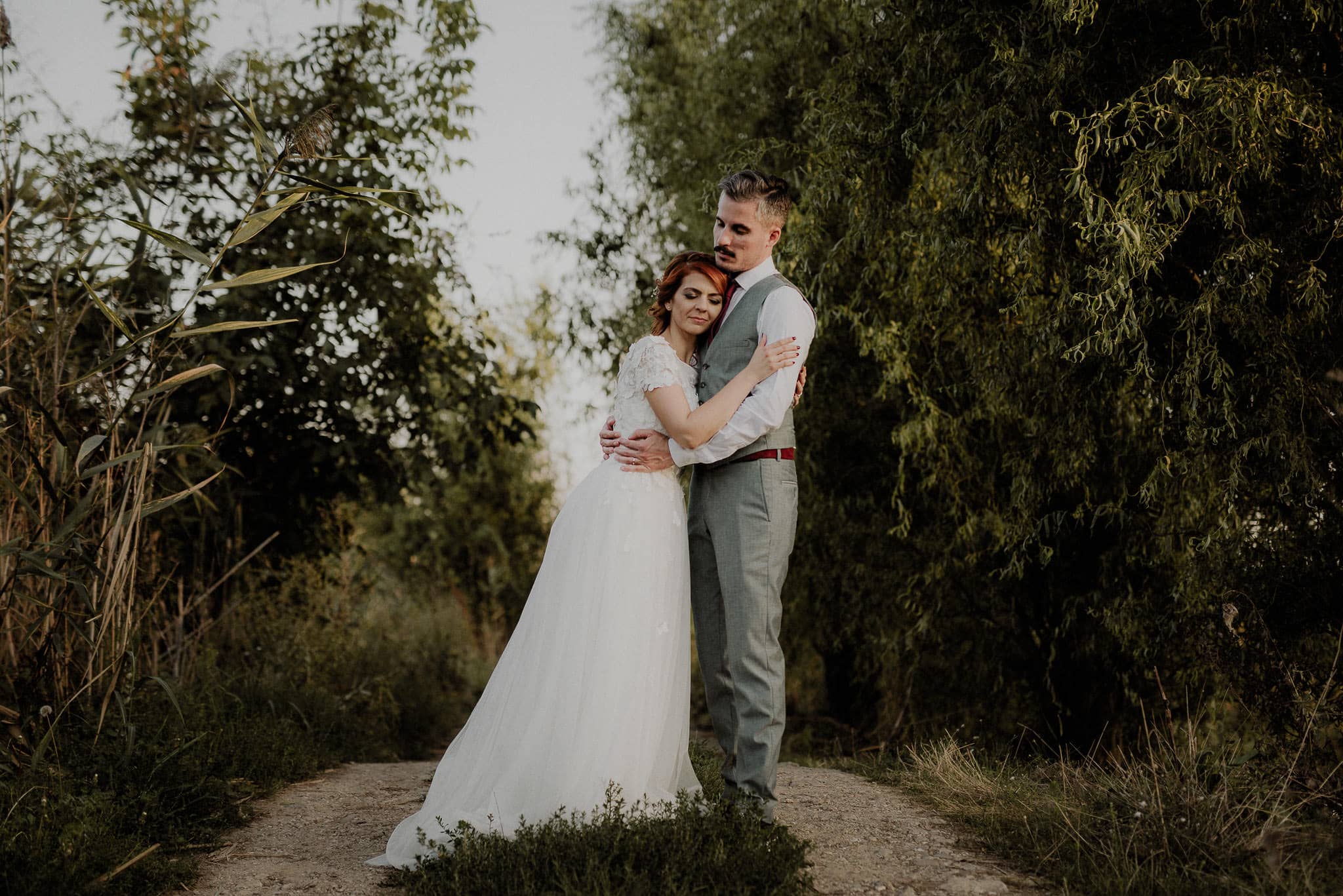 bride and groom share an intimate moment surrounded by nature
