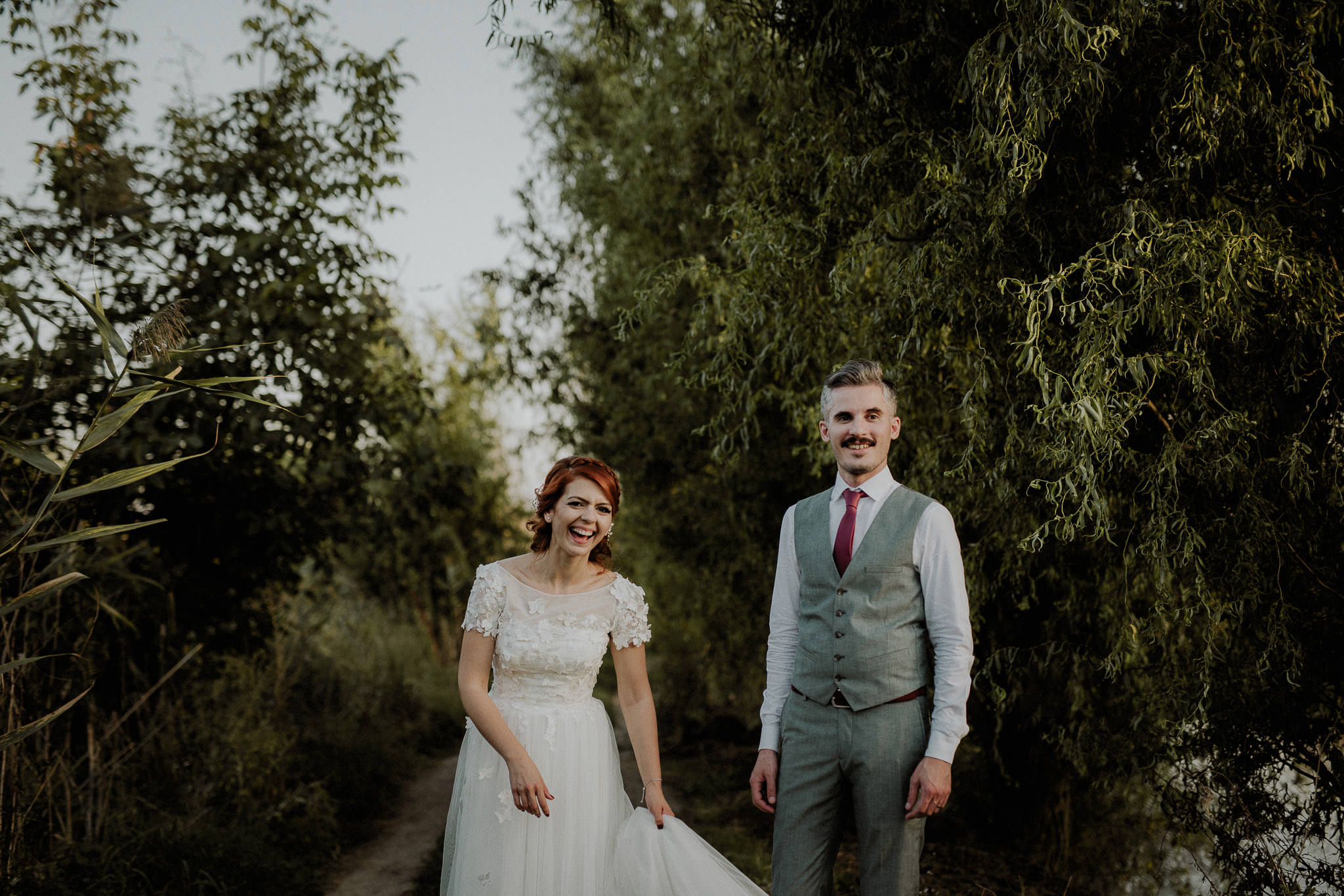 intimate garden wedding in autumn, surrounded by vegetation and a candid portrait of a fun bride and groom