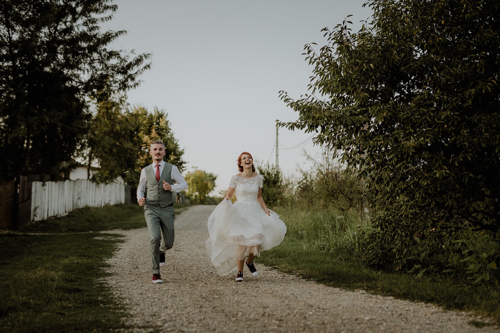 newlyweds running together in the natural outdoors