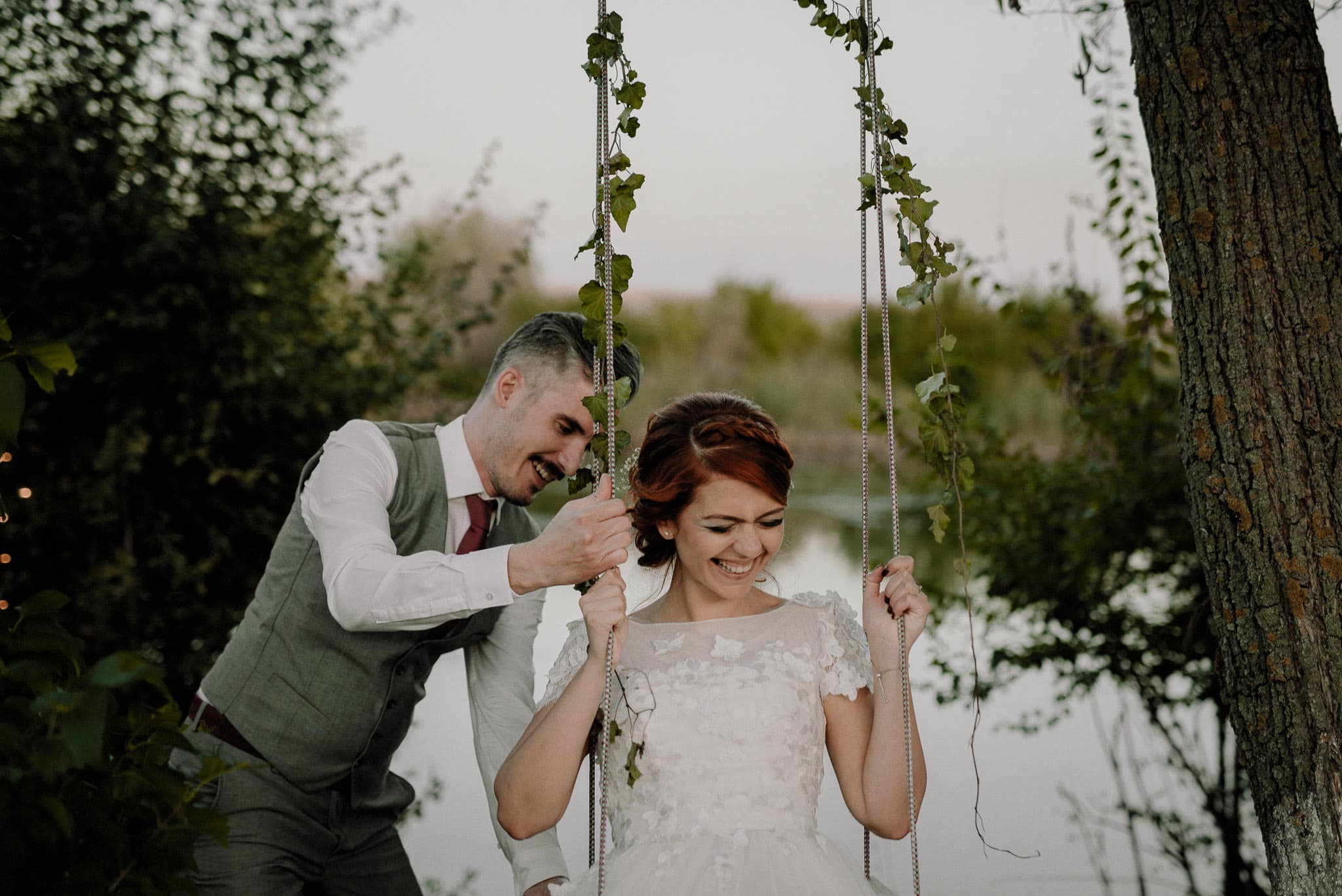 outdoor wedding swing used by fun couple