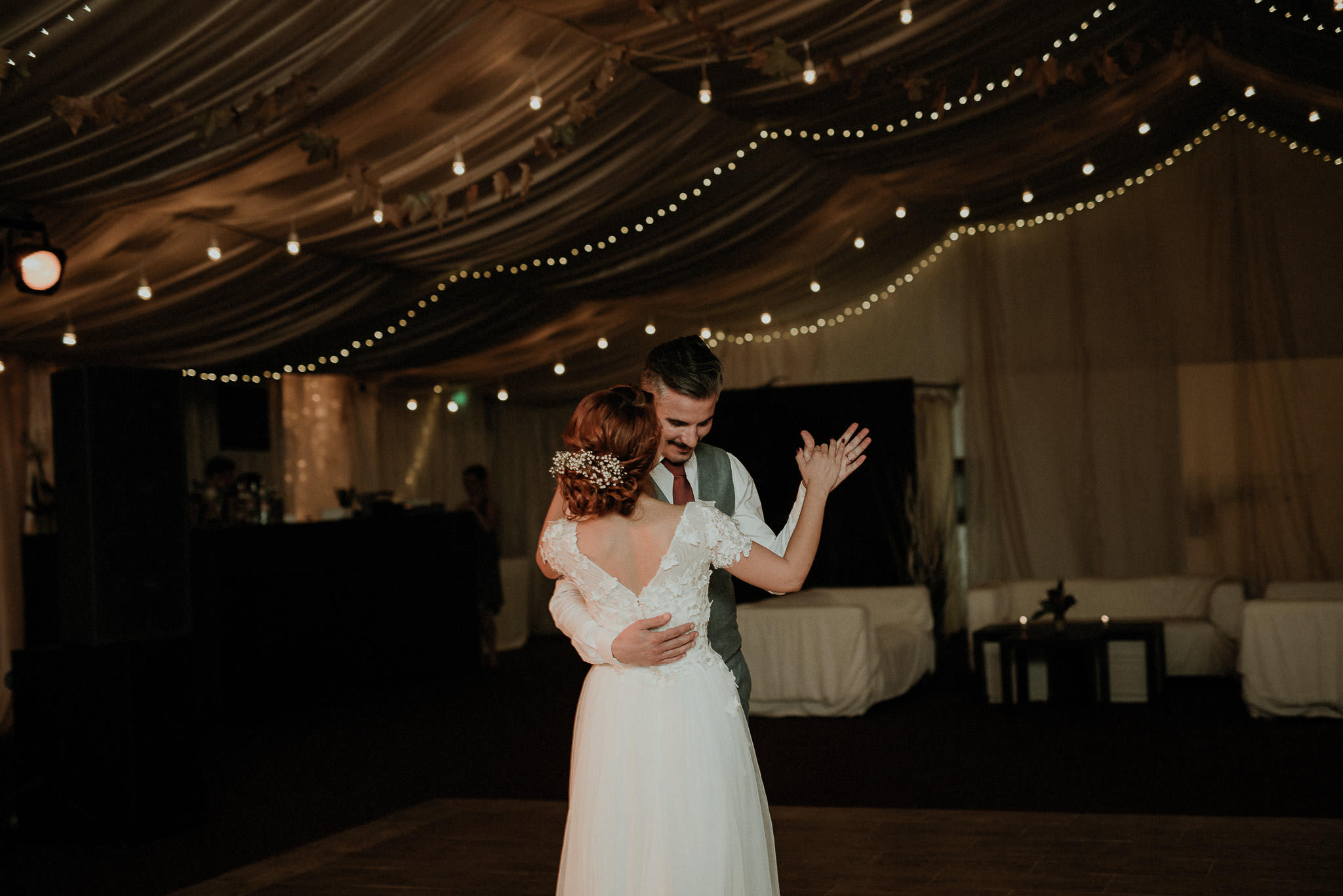 bride and groom share their first dance together
