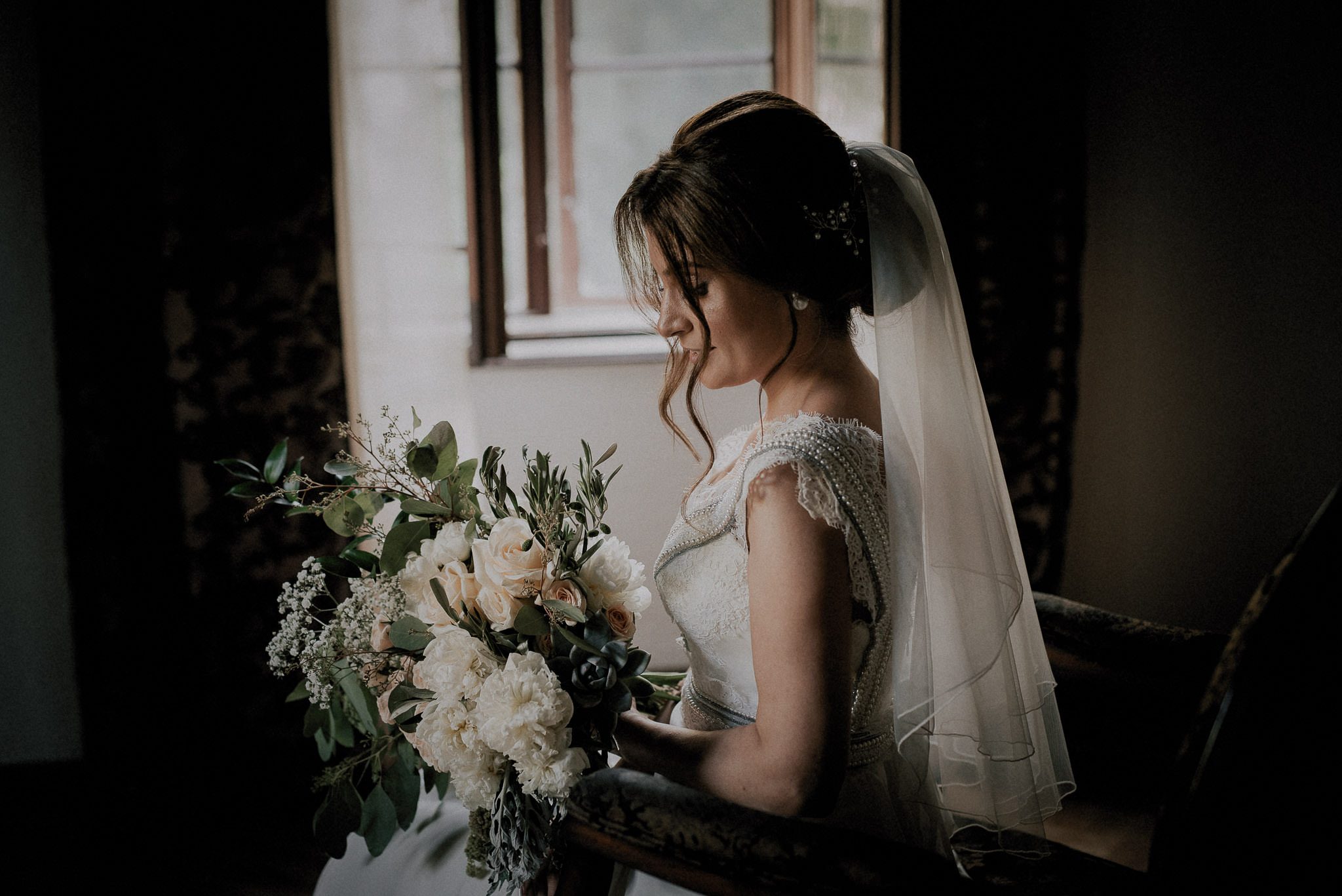 elegant bride loving her natural bouquet