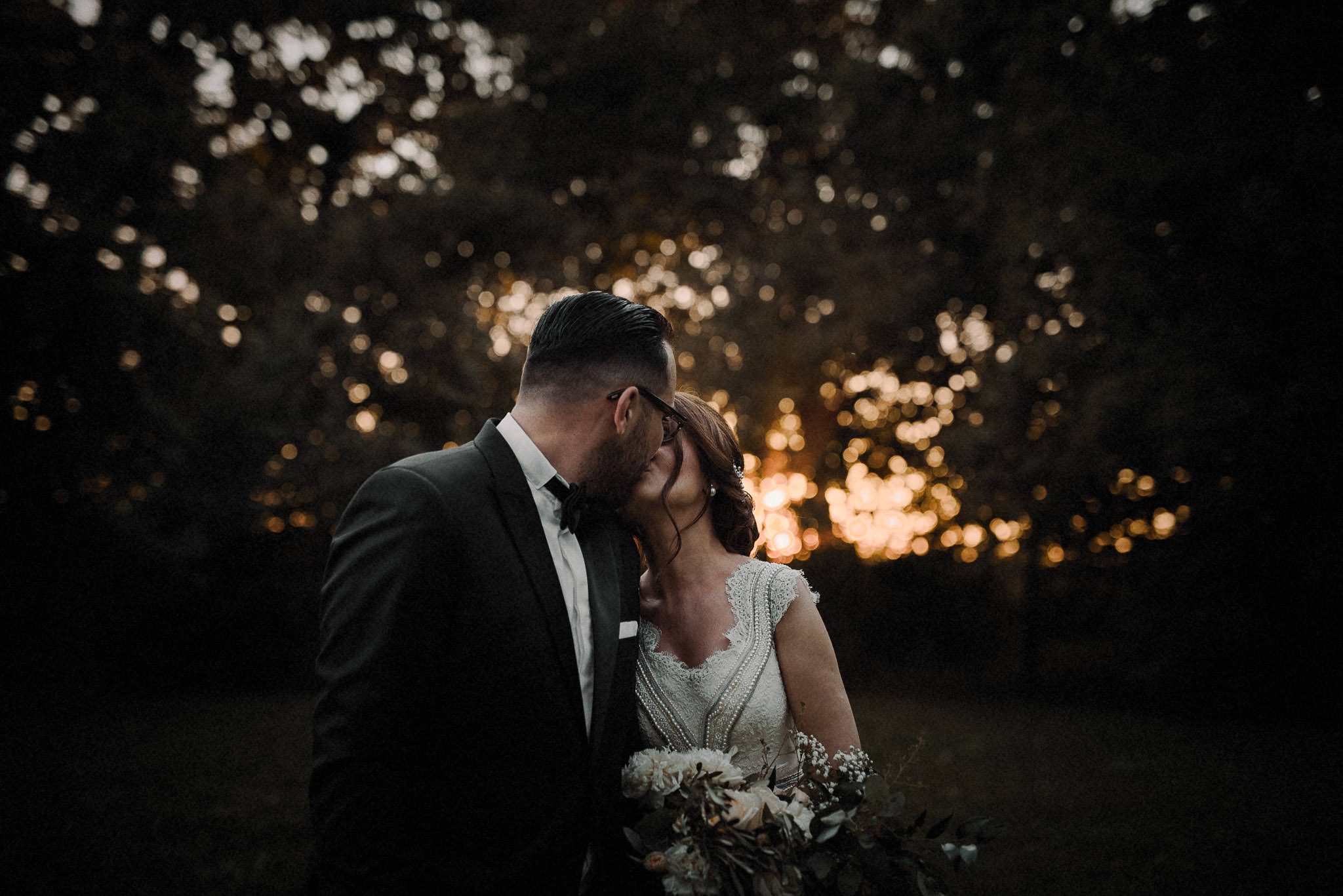 romantic kiss during sunset after the wedding ceremony