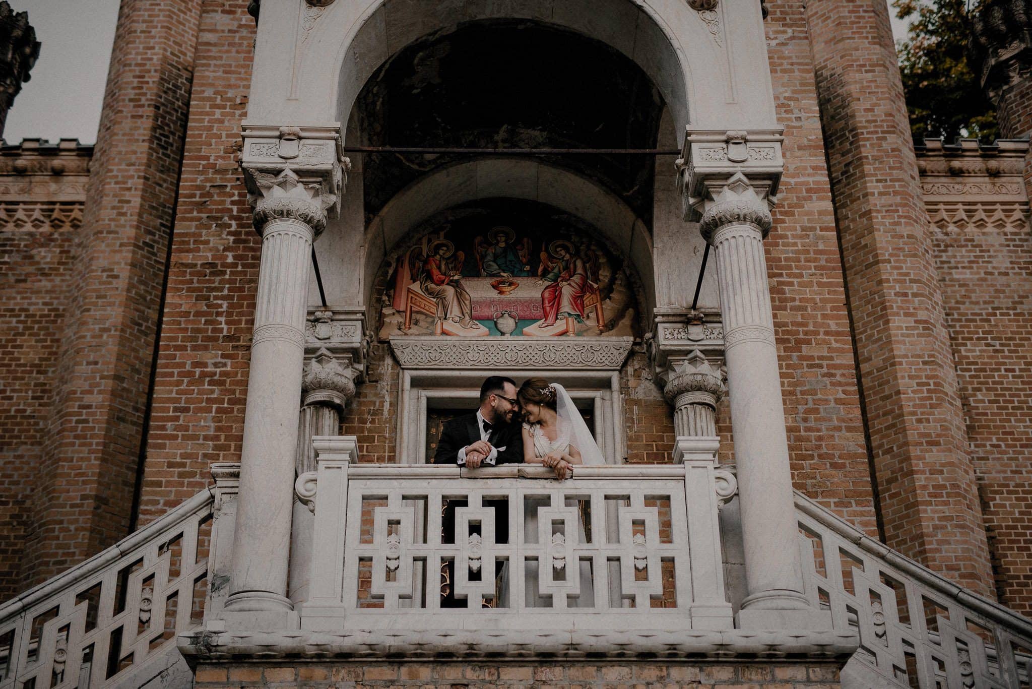 bride and groom share an intimate moment on the balcony