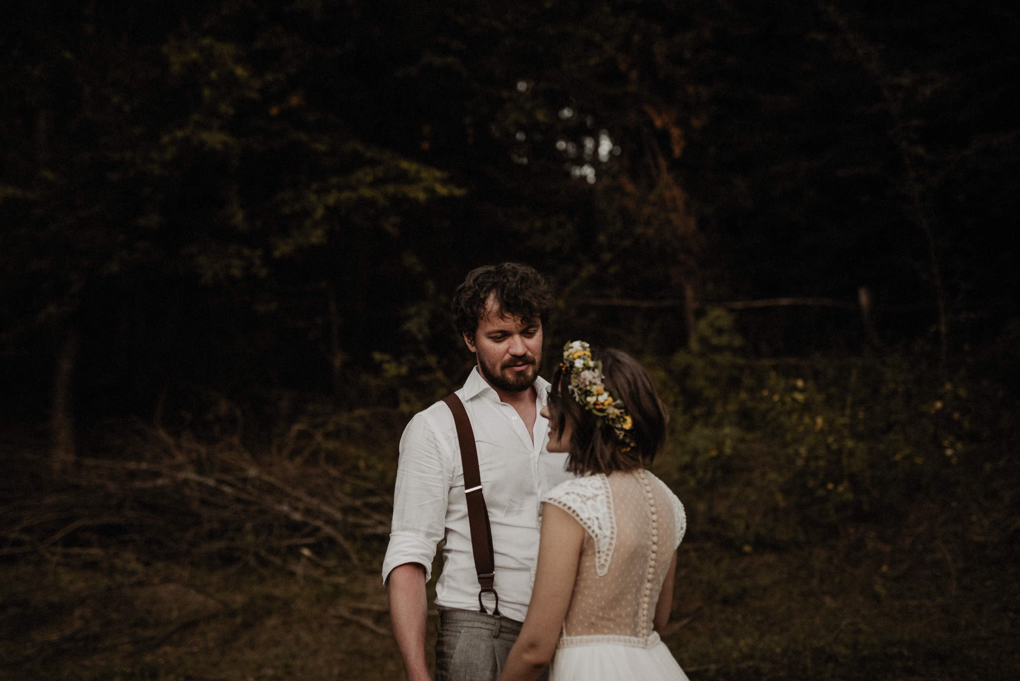 groom looking lovingly to his bride in the middle of nature