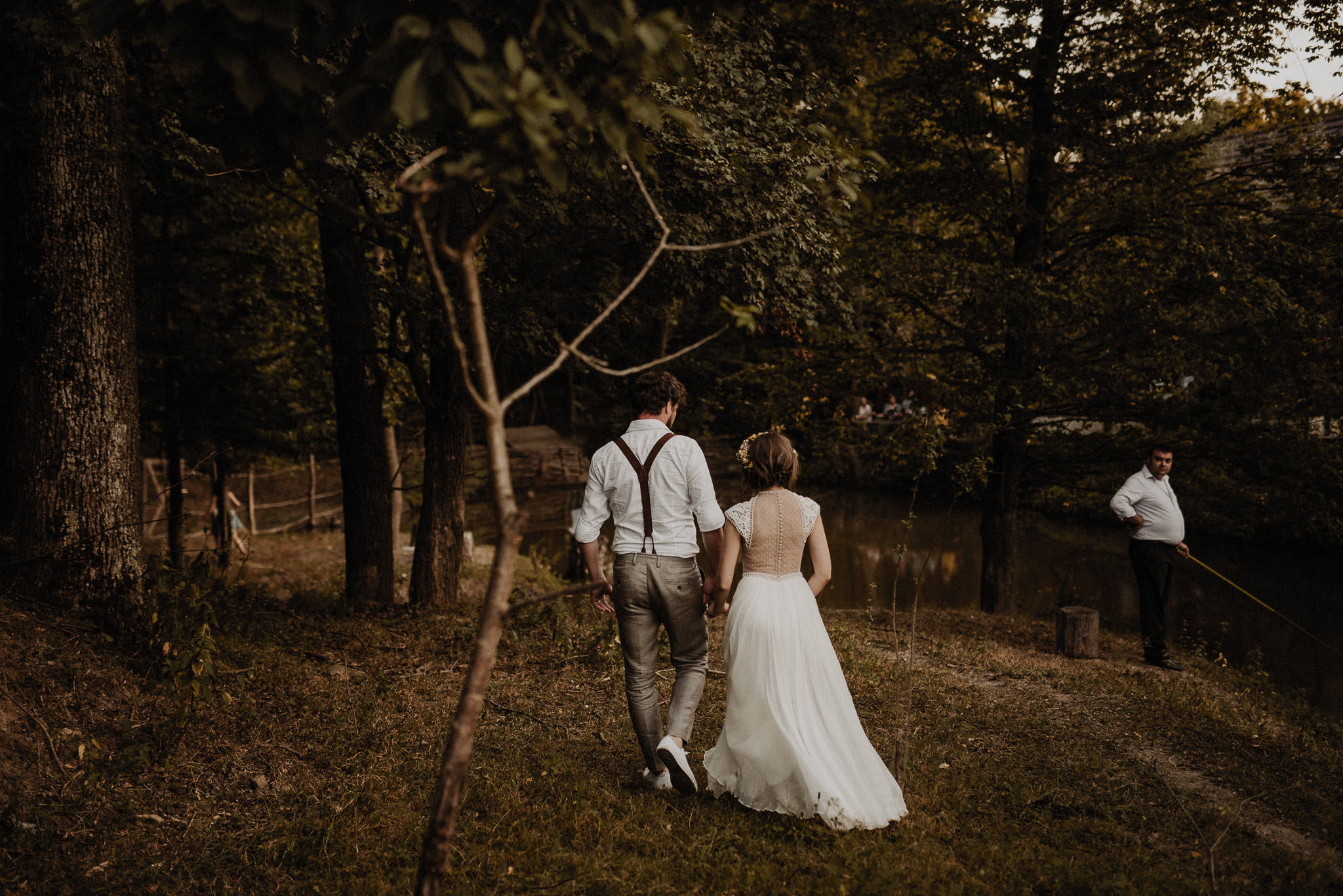 bride and groom walking in the forest
