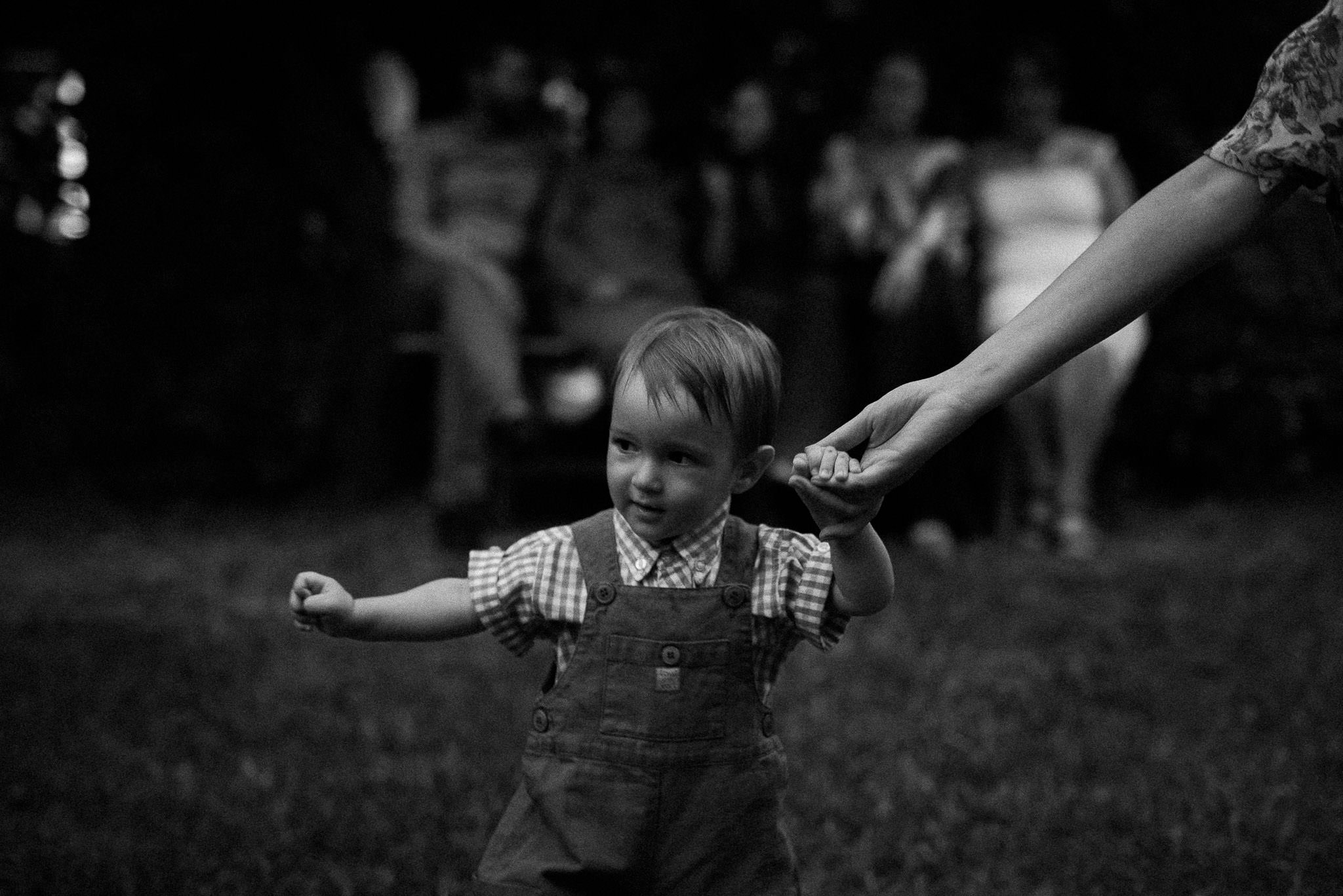 little boy learning to walk during forest wedding