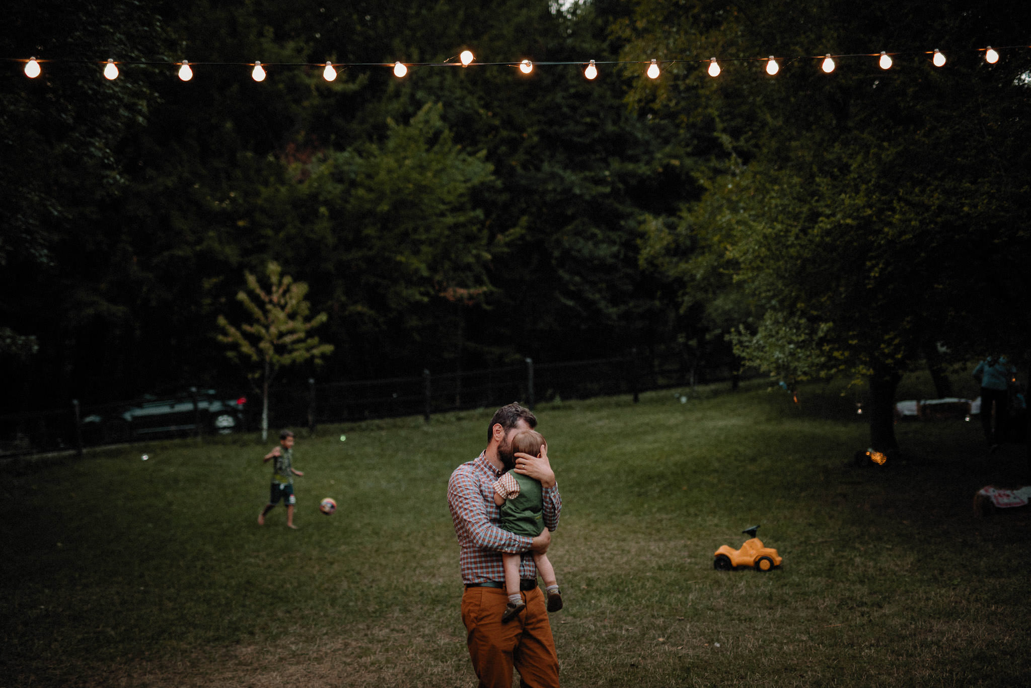 father dancing with his little boy on the lawn during wedding party