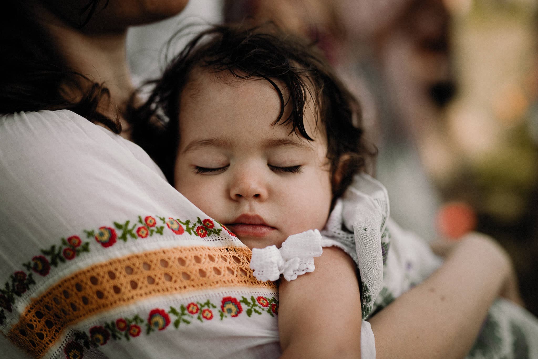 little girl sleeping during wedding ceremony