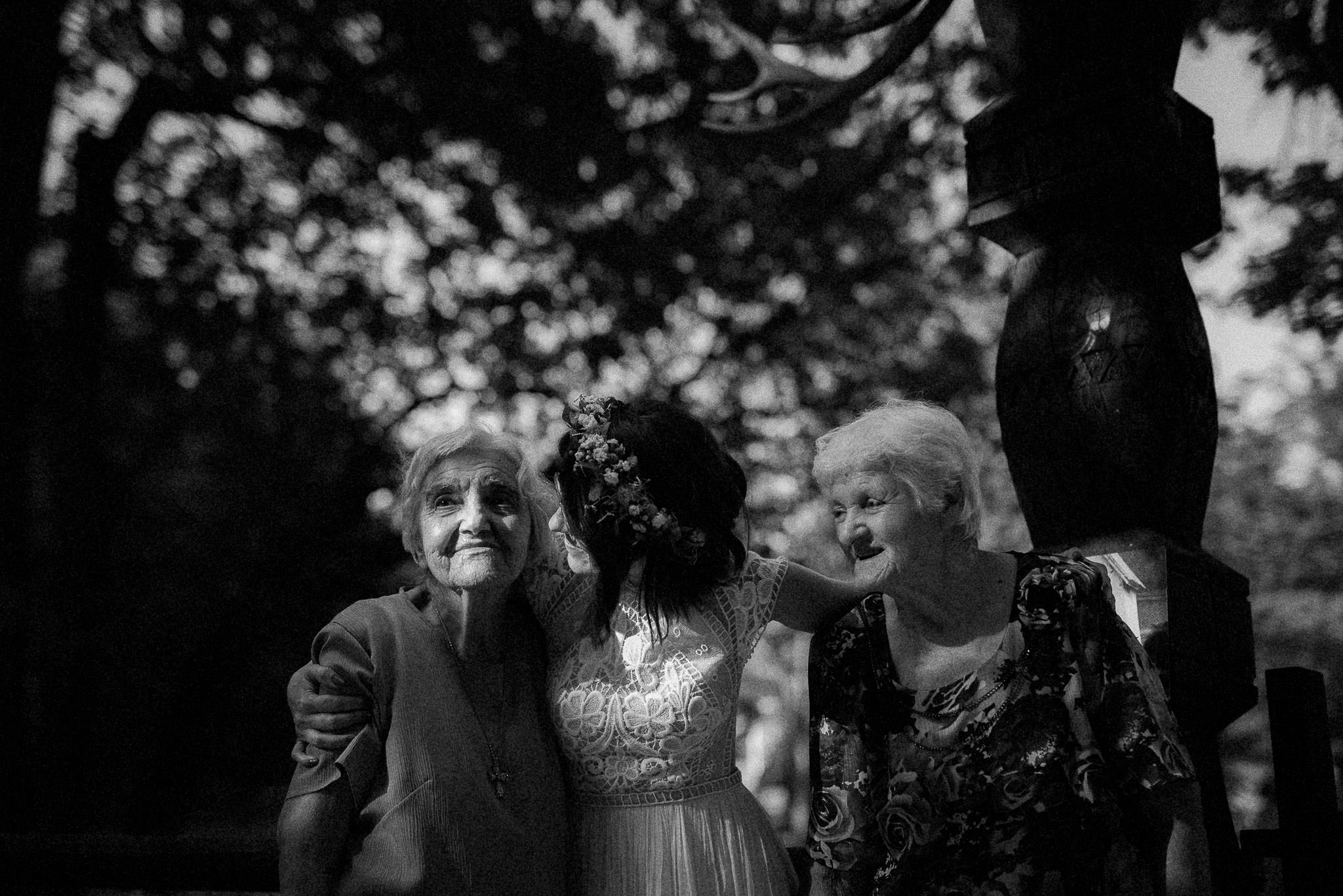 bride hugging her grandmothers