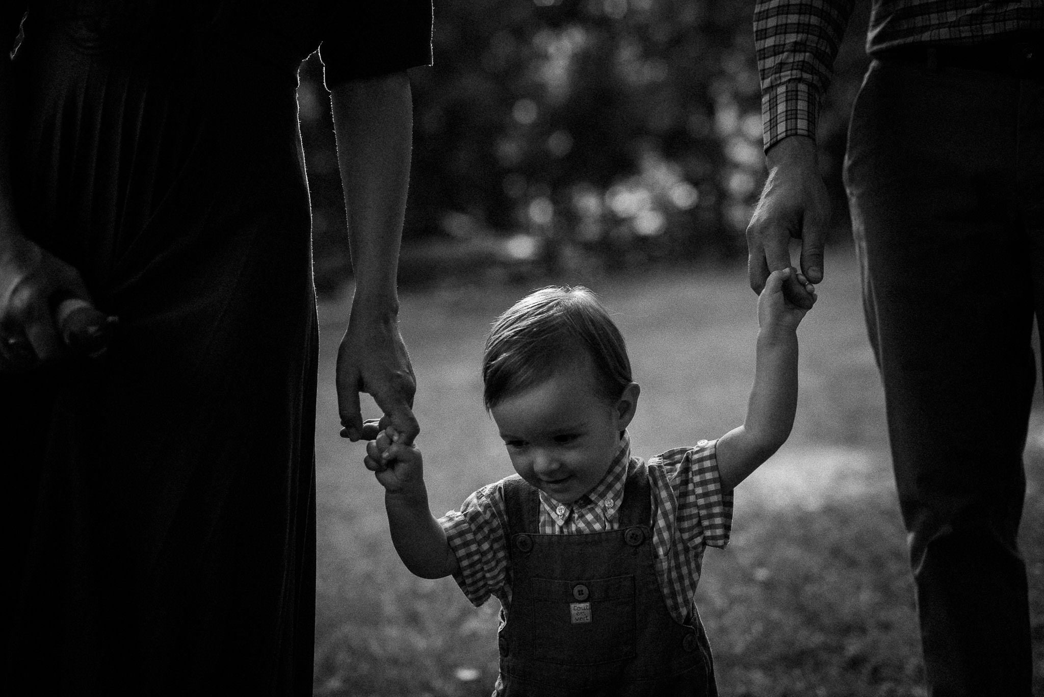 little boy having fun with his parents in the forest during the wedding party
