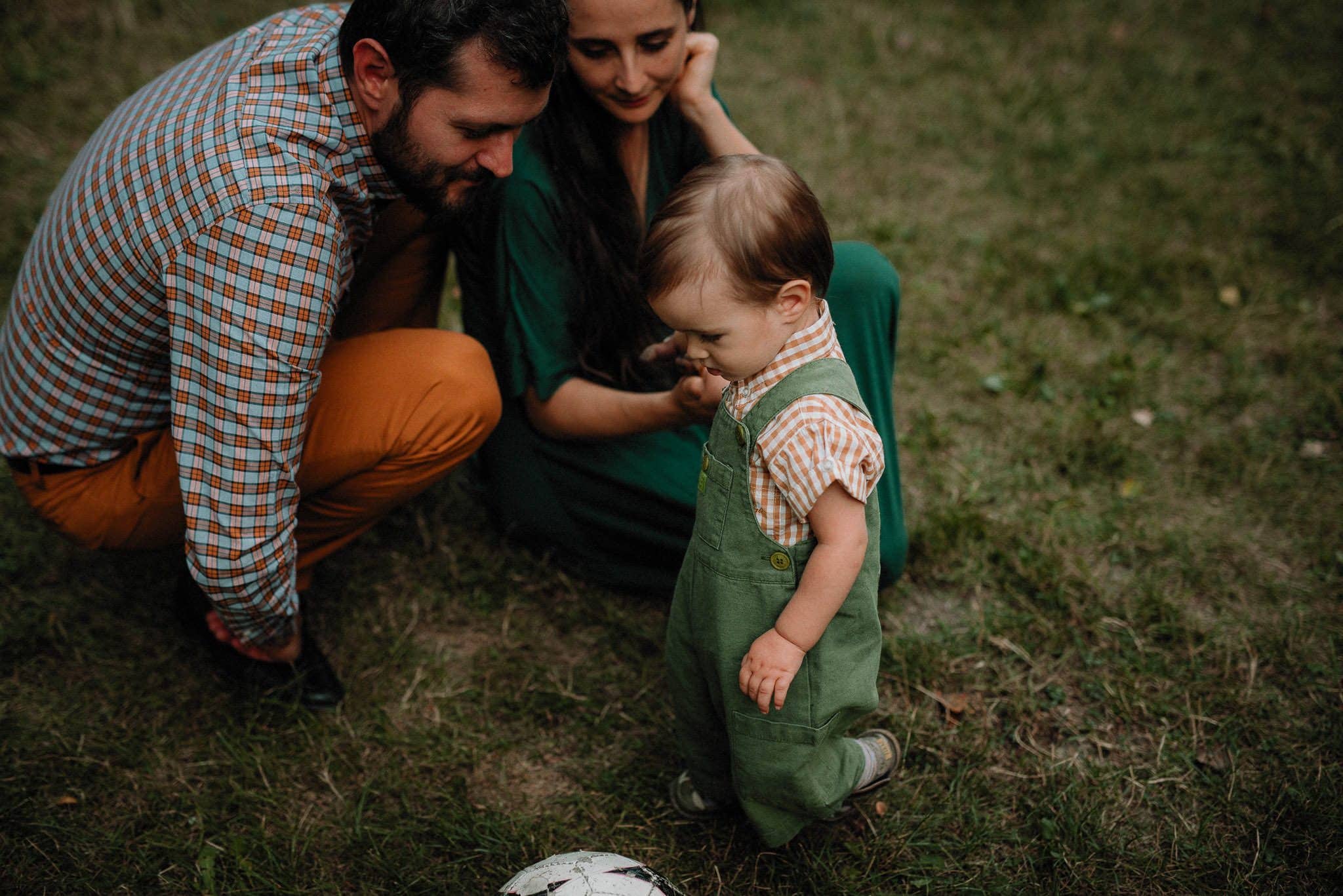 little boy having fun with his parents in the forest during the wedding party