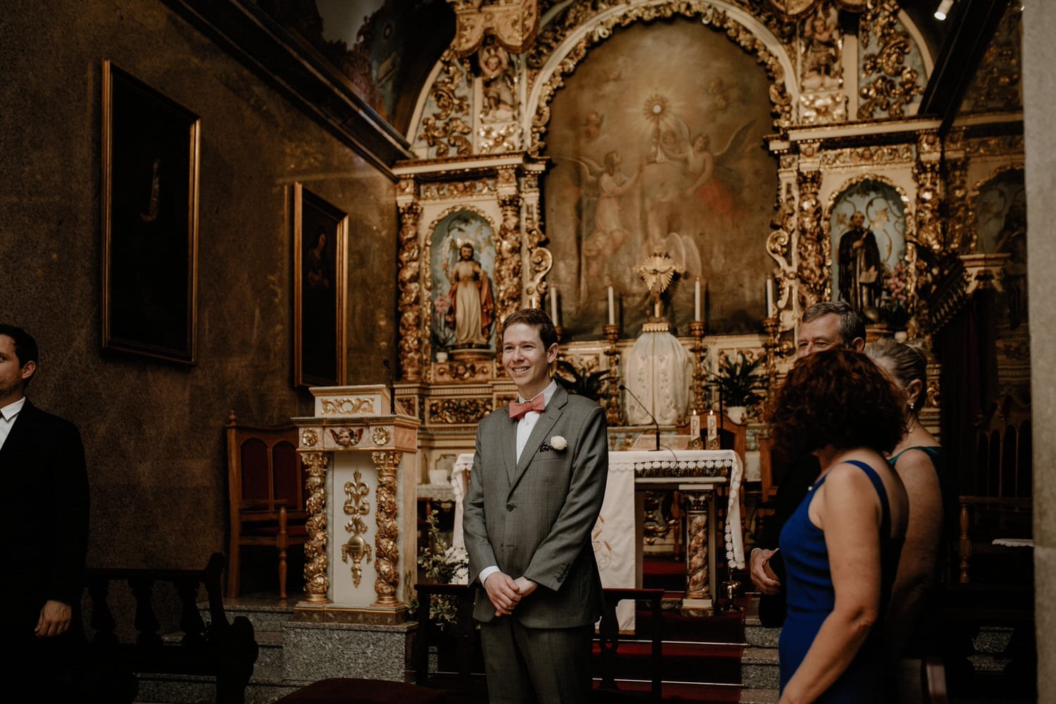 emotional groom waiting for his bride to walk down the aisle