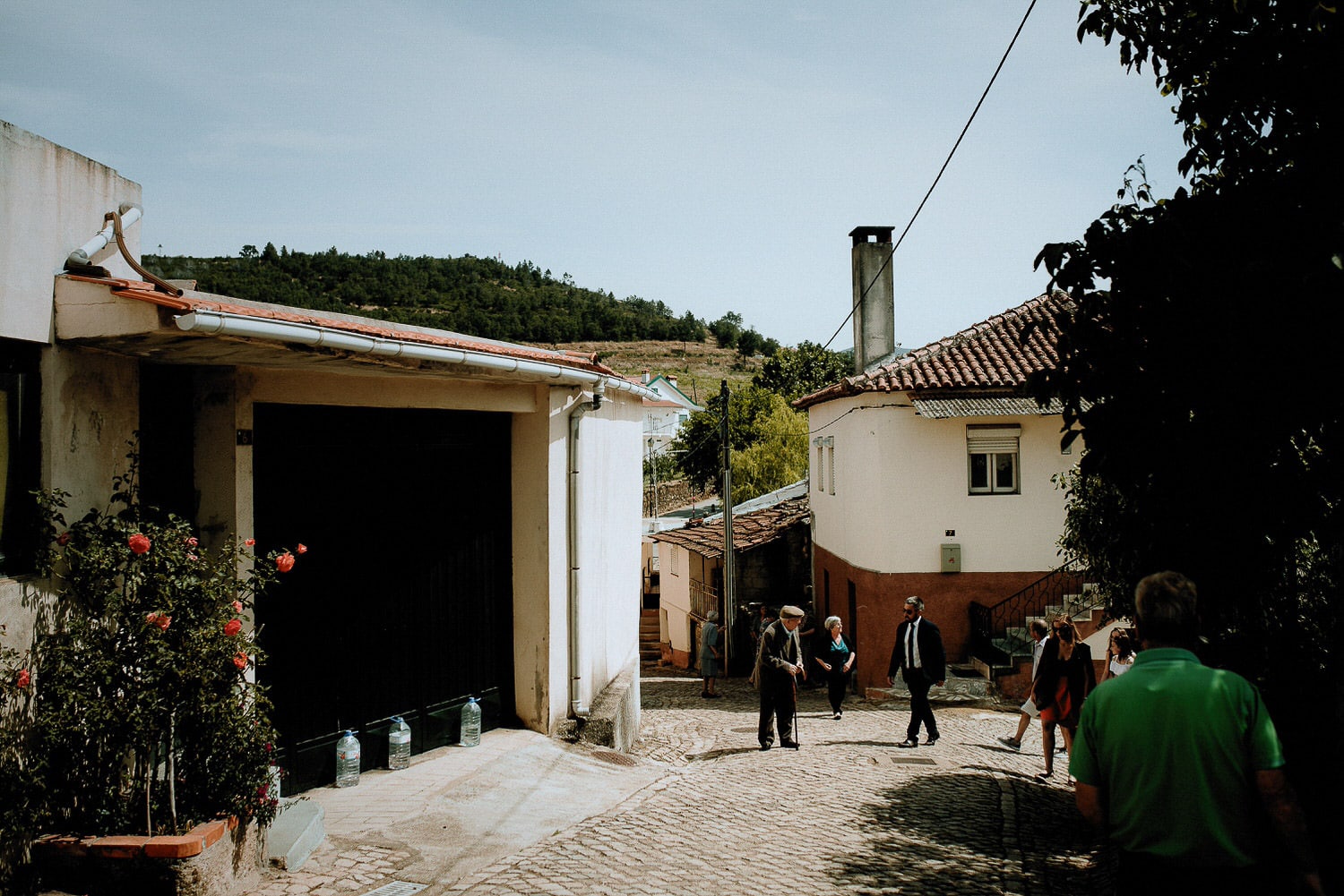 Charming Destination Wedding in the Portuguese Countryside - guests arriving at the ceremony in the small village