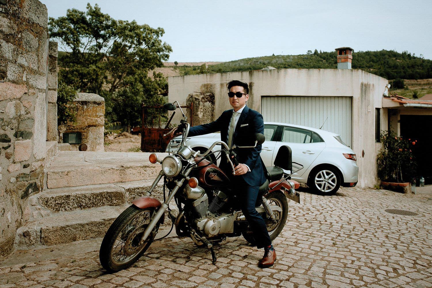 Charming Destination Wedding in the Portuguese Countryside - groom arriving on a motorcycle to the ceremony
