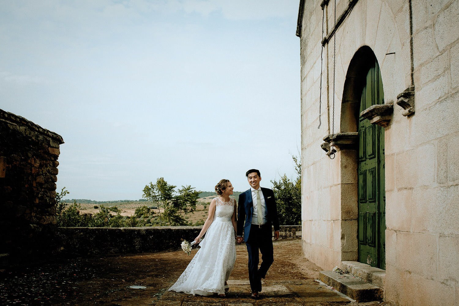 Charming Destination Wedding in the Portuguese Countryside - bride and groom in front of the small village church where they got married