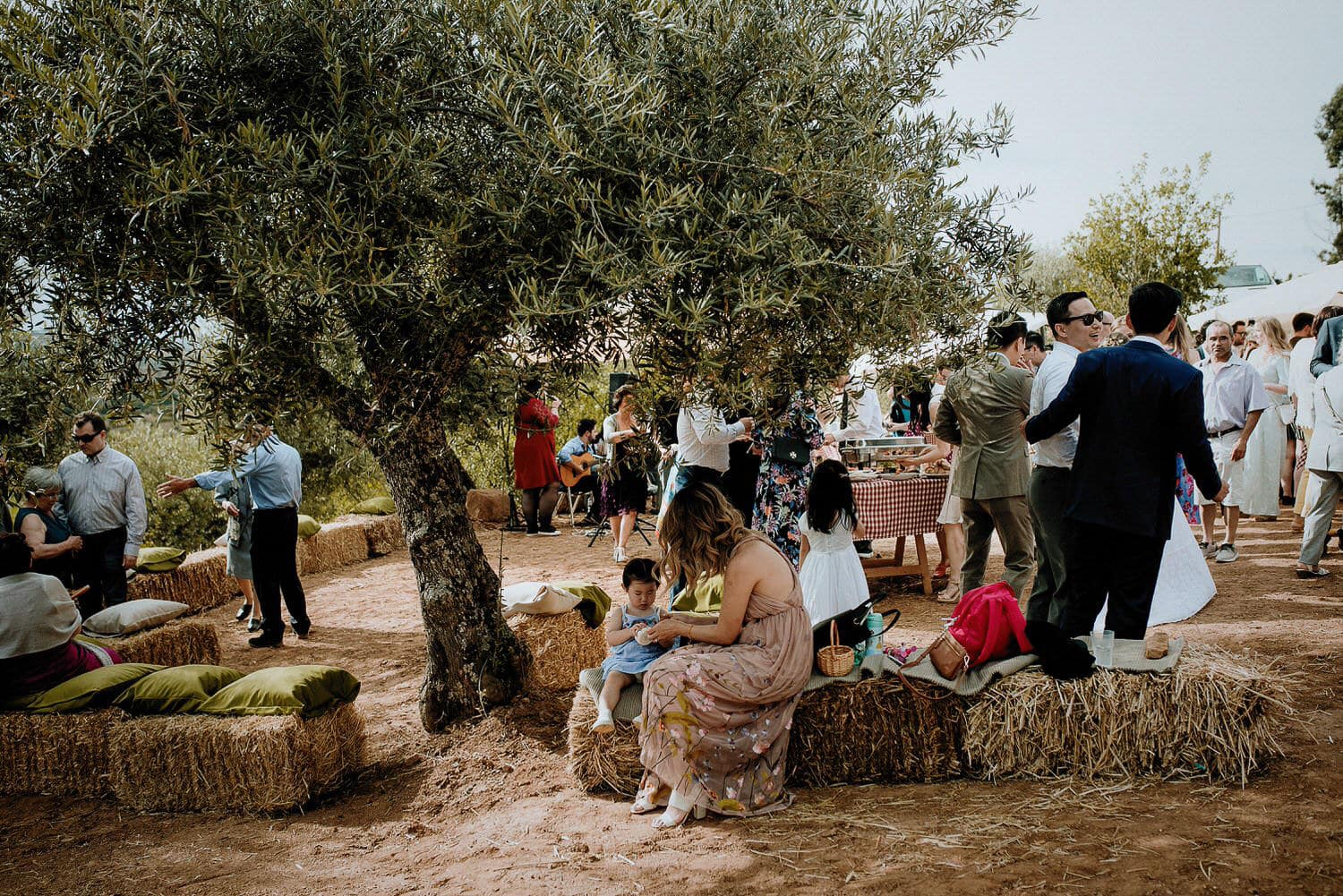 Charming Destination Wedding in the Portuguese Countryside - rustic diy reception with hay bales and olive trees