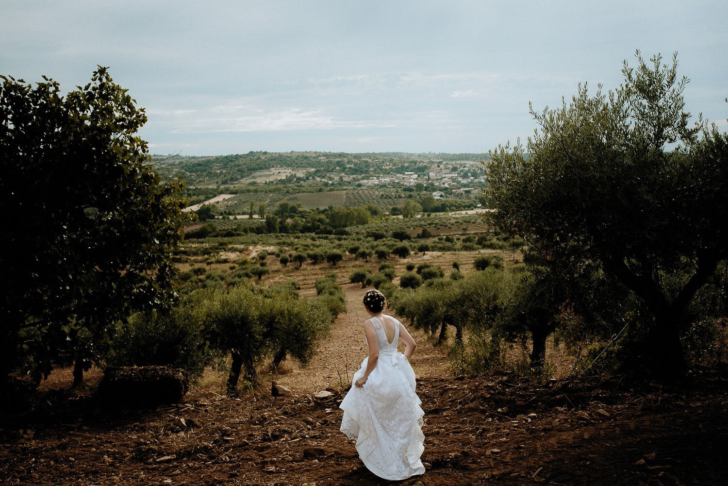 Charming Destination Wedding in the Portuguese Countryside - bride overlooking the beautiful portuguese landscape wearing her mother's dress