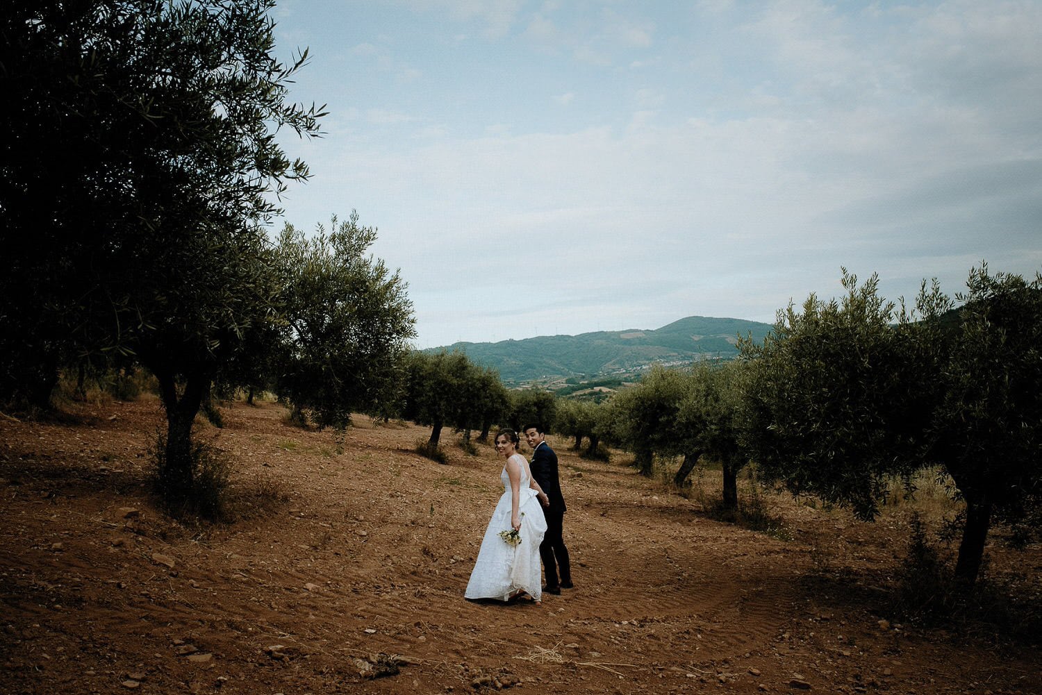 Charming Destination Wedding in the Portuguese Countryside - bride and groom surrounded by olive trees