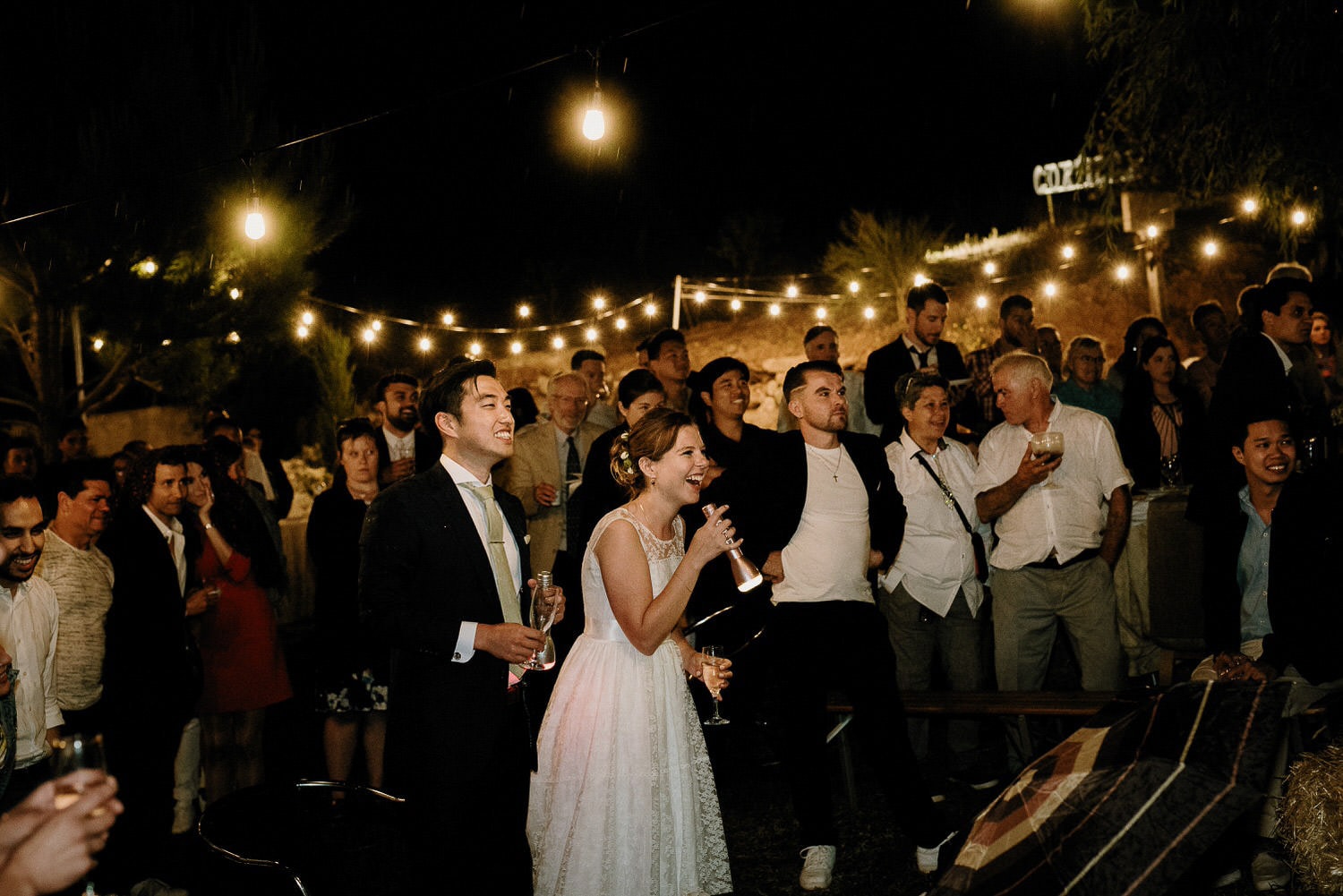 Charming Destination Wedding in the Portuguese Countryside - bride and groom having fun while singing karaoke at their wedding