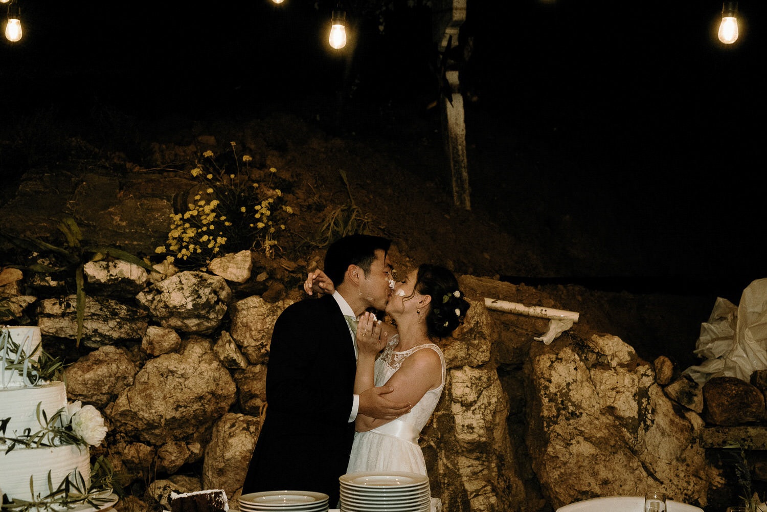 Charming Destination Wedding in the Portuguese Countryside - bride and groom sharing a dirty kiss after putting cake on their faces