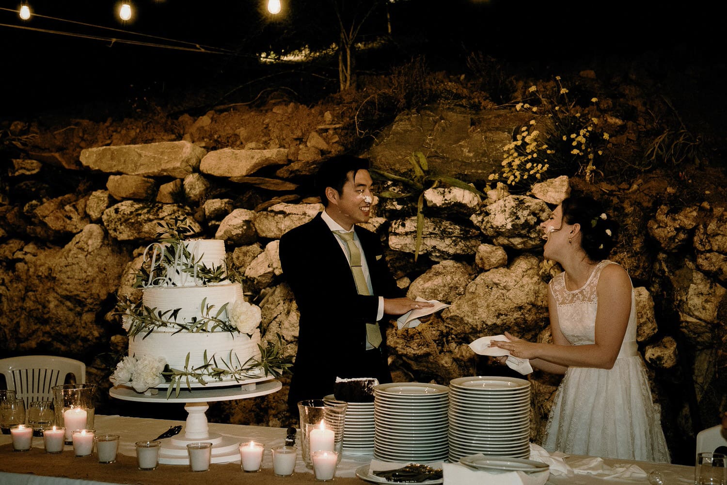 Charming Destination Wedding in the Portuguese Countryside - bride and groom putting cake on each other's faces
